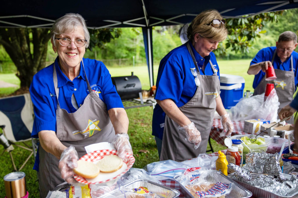 Eastern Star volunteers sharing food at a community event